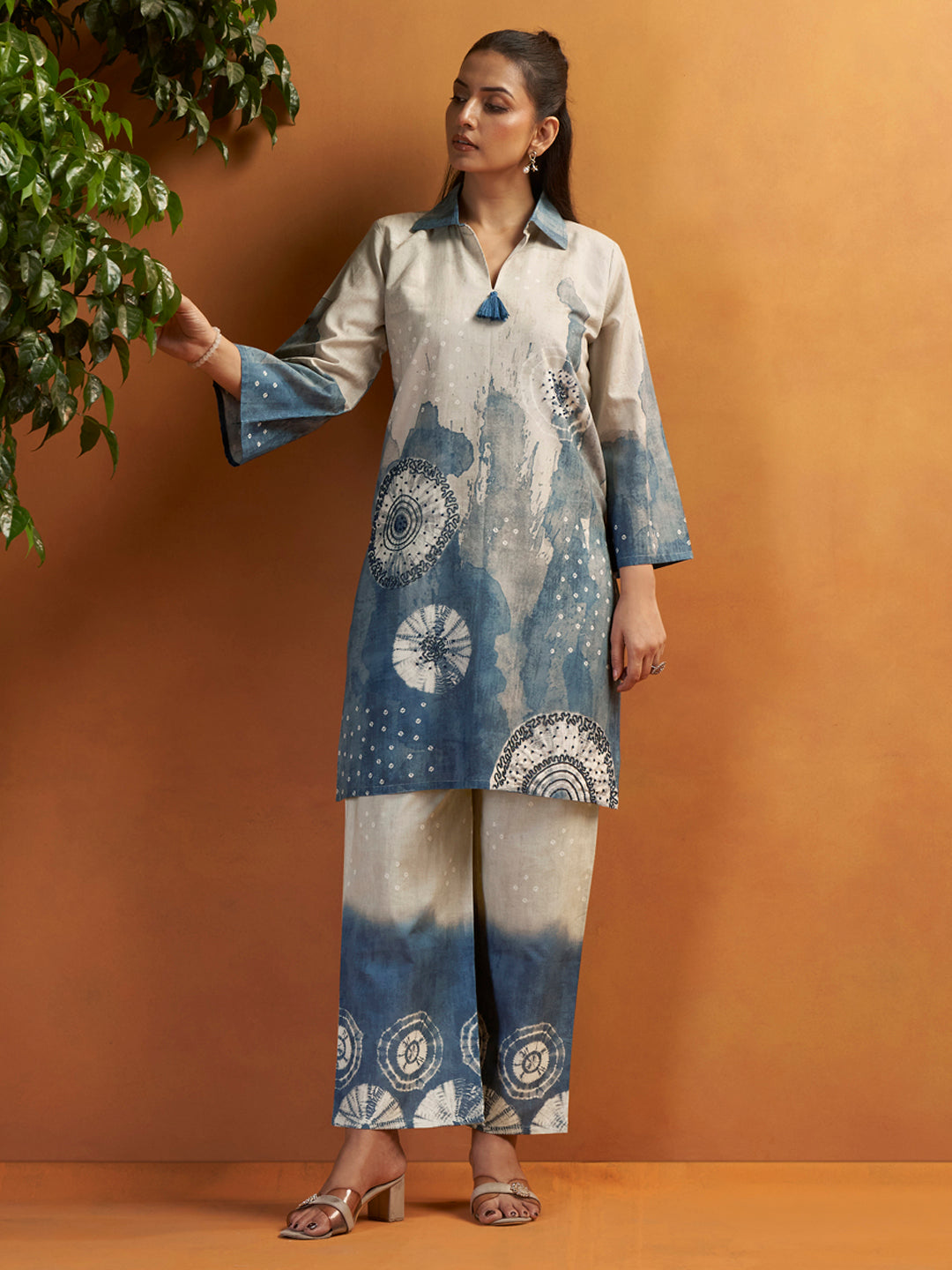 Designer suit set featuring contrasting border trims and fine hand-stitched hemline accents